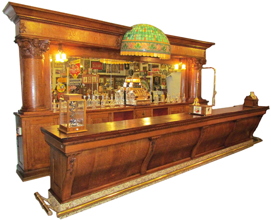 Rare Brunswick saloon front and bar back, made circa 1895-1905 of quartersawn oak.  Image courtesy Showtime Auction Services.
